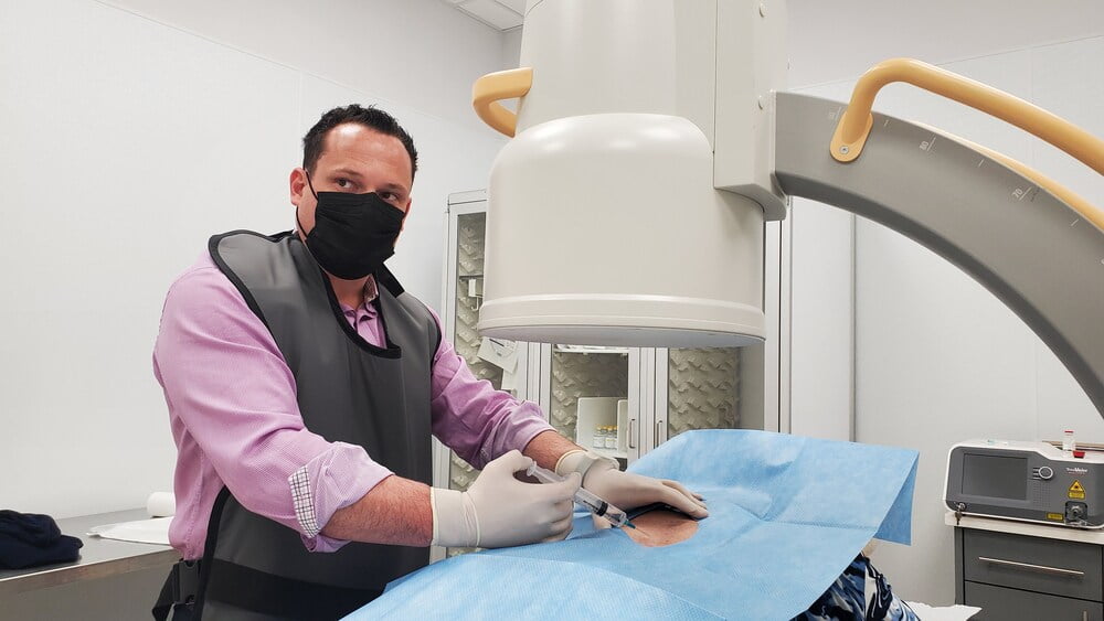 Dr. George Bolotin working with patient